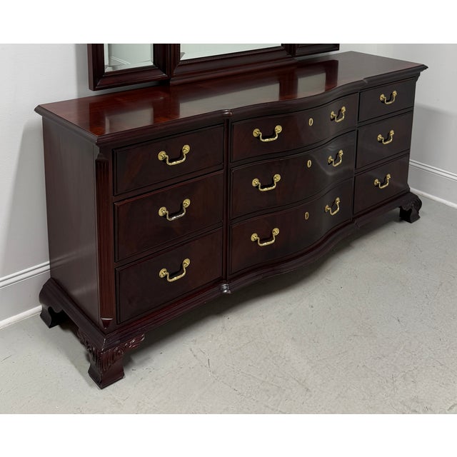 A Chippendale style triple dresser by Thomasville, from their The Mahogany Collection. Mahogany with flame mahogany drawer...