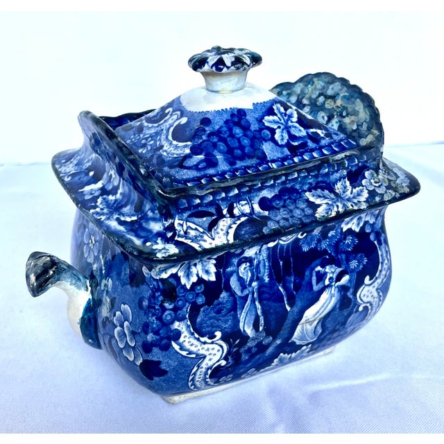 An exceptional piece of early 19th-century English pearlware, this antique deep blue transfer-printed covered sugar bowl...