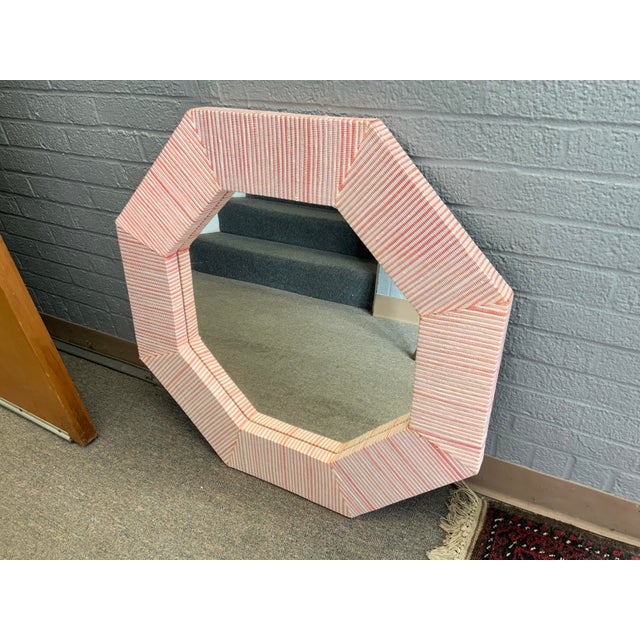 20th century octagonal wall mirror. Mix of pink and white faux grasscloth.