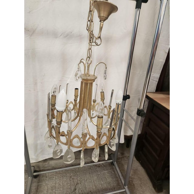 Chandelier of the 70s in bronze and glass metal By Gaetano Sciolari This piece is attributed to the mentioned...
