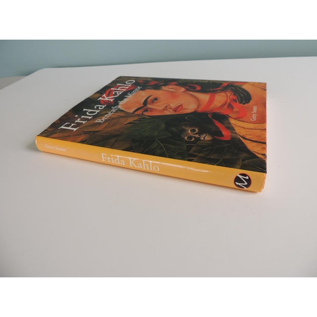 Frida Khalo Beneath the Mirror Hardcover Book Behind Frida Kahlo’s portraits, lies the story of both her life and work. It...
