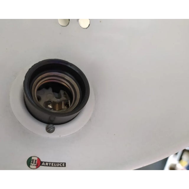 Large wall lamp with black lacquered iron structure and aluminum diffuser by Paolo Rizzatto, produced by Arteluce in 1970....