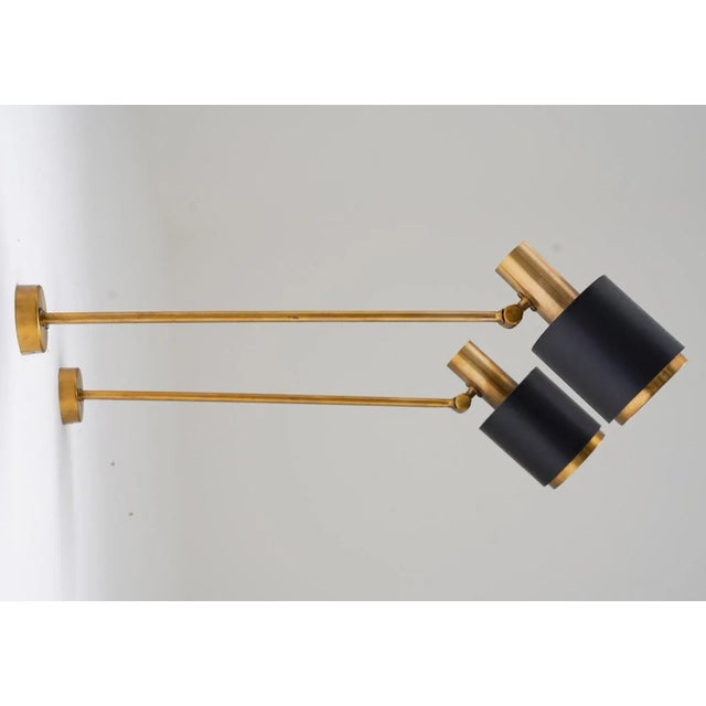 Rare midcentury wall lamps, produced by falkenbergs, sweden 1960s. The lamps feature a long brass rod, holding the...