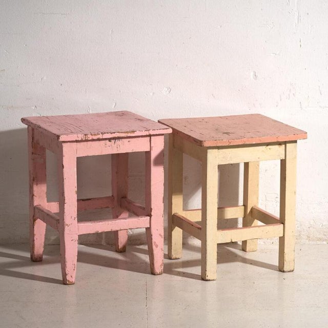 A pair of antique bedside tables in pine wood, with a square top and four tapered legs tied by box stretchers. They...