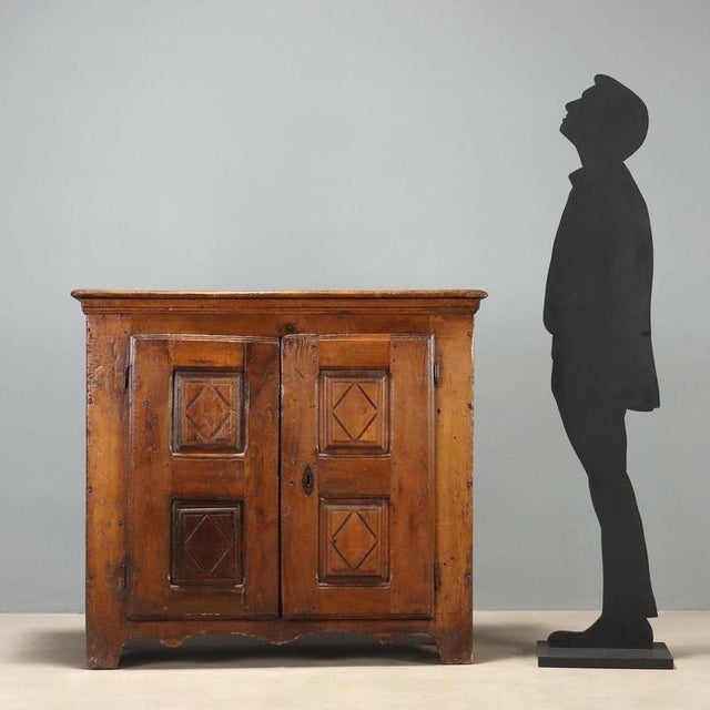 Chestnut sideboard dating back to the late 17th century, Italian craftsmanship. The front features a pair of bipartite...