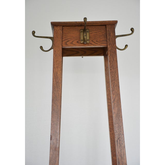 This superb English Arts and Crafts solid oak coat stand, manufactured by the historic British firm Astrola, is a...