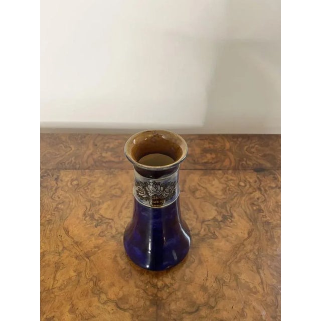 Antique Royal Doulton shaped vase having an antique Royal Doulton shaped vase with a blue ground with a band of decoration...