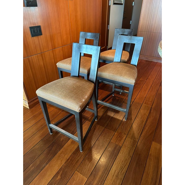 These are vintage Donghia counter-height stools featuring a sleek and modern design. The stools have a distinctive open-...