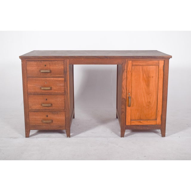Olaio desk in oak. A representative example of functional and robust 20th century design, it has a solid structure with a...