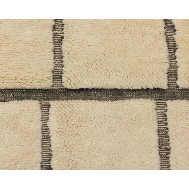 Brick by brick, line by line: an architectural grid softened by the human hand. Chocolate brown lines divide a natural...