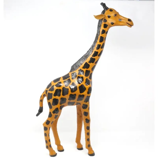 A vintage, handmade leather figure in the form of a giraffe. Hand-painted details. Good vintage condition; minor wear...