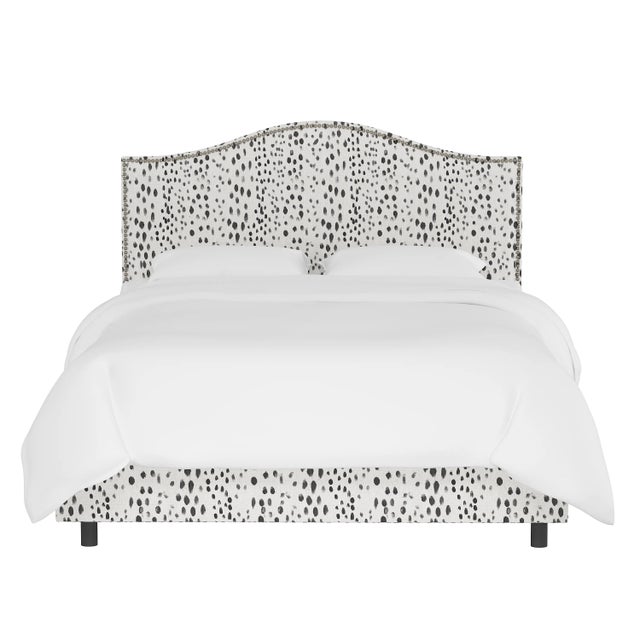 Give your interior a lift with the Bed. Featuring the delicate curves of a classic camelback design, with subtle nailhead...