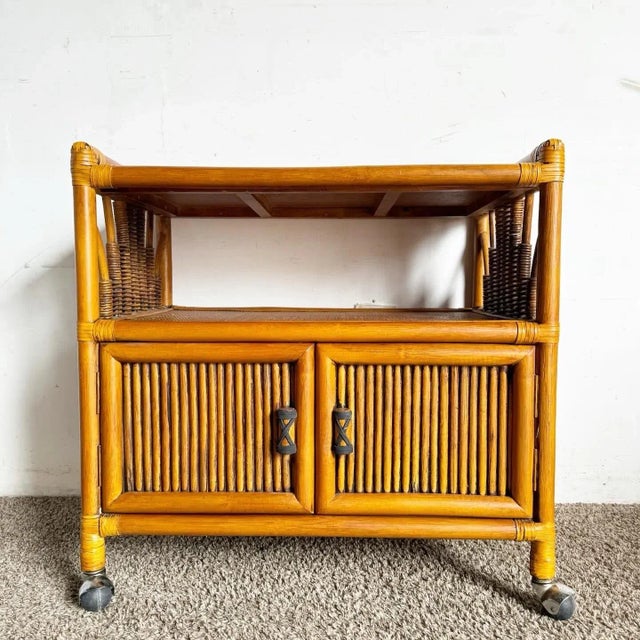 Add a touch of tropical elegance to your entertaining space with this Boho Chic Bamboo Rattan and Wicker Bar Cart. This...