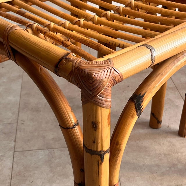 An elegant set of four Italian dining chairs, dating back to the 1960s and crafted from high-quality bamboo and rattan....