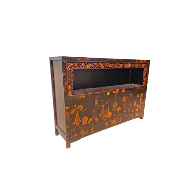 This antique cabinet features hand-painted flowers and traditional vases. The upper section includes a large, open display...