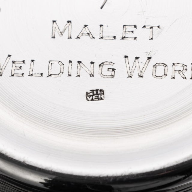 A 20th century english solid silver travel cocktail shaker, featuring an engine turned pattern throughout. The base is...