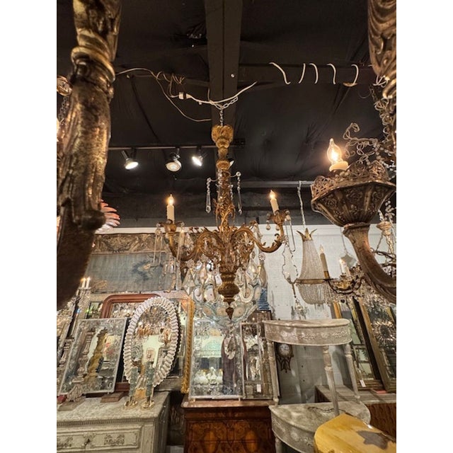 This 19th Century Italian Bronze and Crystal Chandelier is a stunning piece that exudes elegance and sophistication....