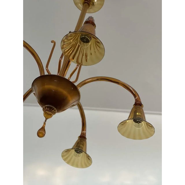 1960's Murano Glass Chandelier with five arms in amber. Produced in Italy during the 1970's. 5 Light sources (E26). Glass...