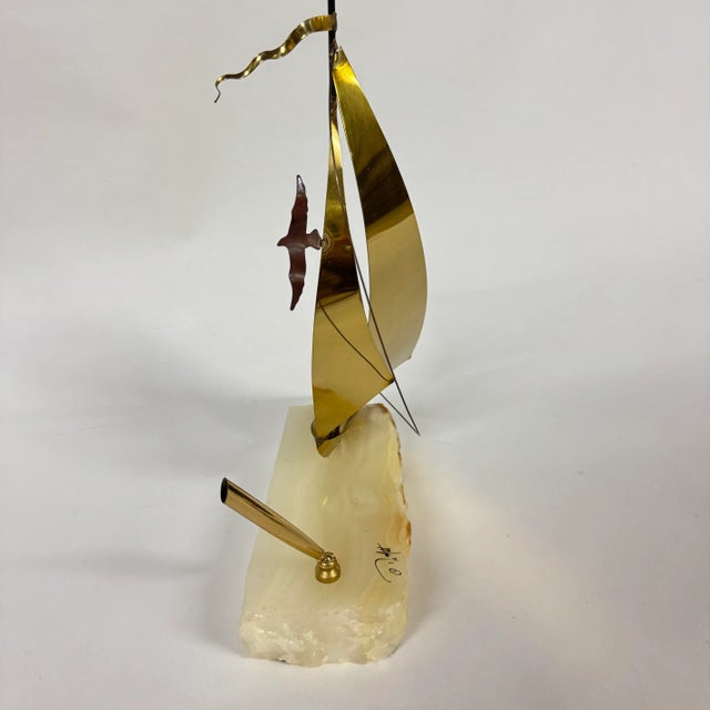 Signed brass sailboat with seagull sculpture with pen holder on onyx base. What one might call functional artwork. In...