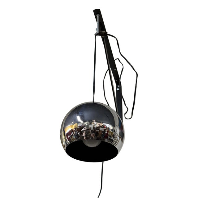 Wonderful space age mid-century modern hanging ball light with a reflective silver exterior. Has a 7 foot long cord that...