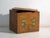 This antique painted trunk in pine wood features a front over an ochre yellow ground with two symmetrical panels showing...