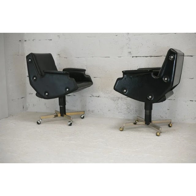 Pair of swivel armchairs, black leatherette and steel, Italy, circa 1960. Wear consistent with age (4 small discrete...