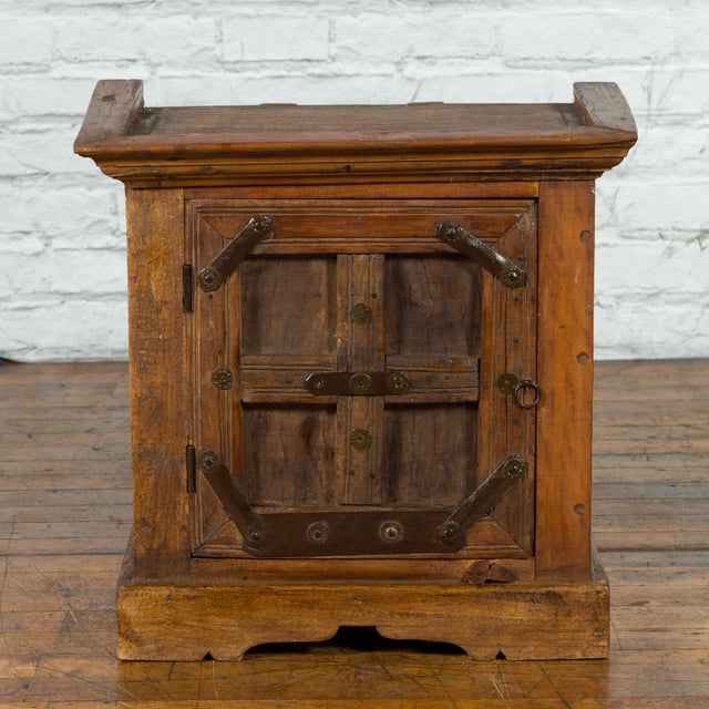 A vintage Indian sheesham wood side cabinet from the mid 20th century with natural finish, single door, iron hardware,...