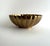 Elegant vintage brass bowl featuring a beautifully fluted, scalloped design with a warm golden patina. Its reflective...