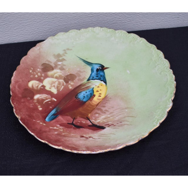 Antique: Early 20th Century Round Decorative Plate with a Scalloped Edge and Hand Painted Floral & Bird Details. The Maker...