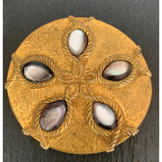 A poudrier in bronze by Parisian art jeweler Line Vautrin (1913-1997) circa 1945, the name of this lovely compact box is...