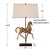 This captivating table lamp is designed as a striking sculpture. Crafted in an aged brown finish with subtle gold accents...