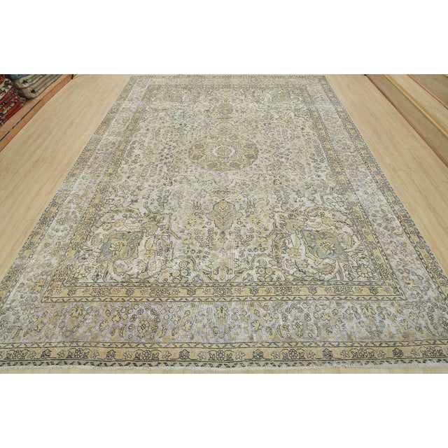 An authentic vintage traditional Tabriz rug hand-knotted with an all-wool pile on a cotton foundation. This oriental rug...