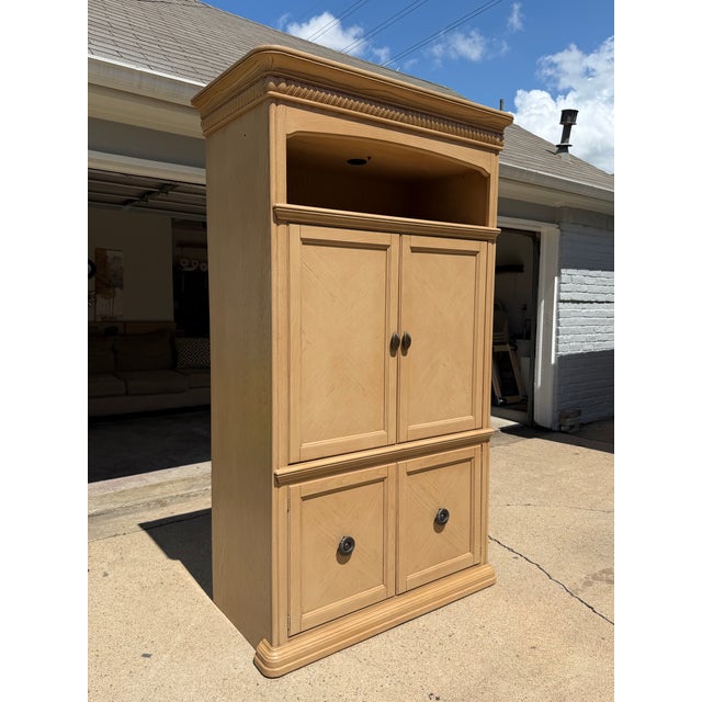 Huge cabinet with traditional paneled doors, and original decorative hardware. Large open door compartment and enclosed...