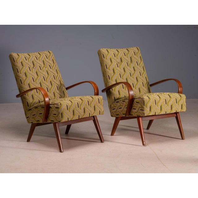 A pair of bentwood lounge armchairs designed by Jaroslav Šmídek, produced in Czechoslovakia. The chairs feature sculptural...