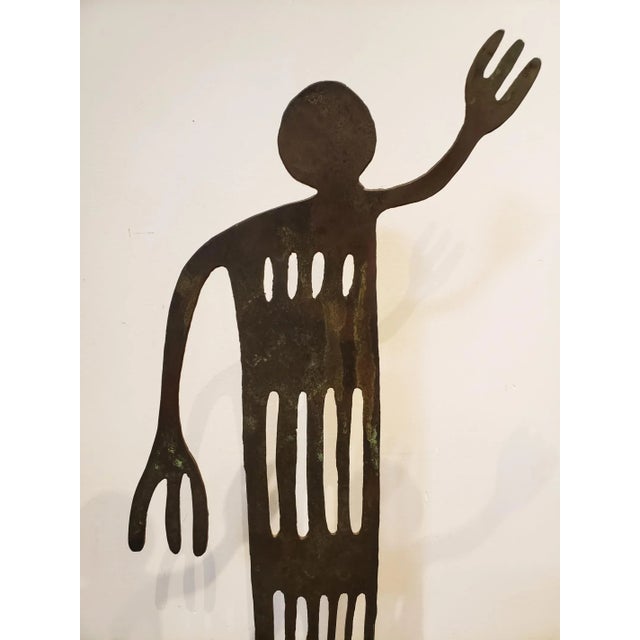 Large patinated iron sculpture (55.5" high x 18" wide) of Native American humanoid hieroglyphic figure. Cut out of 1/4"...