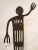 Large patinated iron sculpture (55.5" high x 18" wide) of Native American humanoid hieroglyphic figure. Cut out of 1/4"...