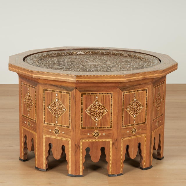 Impressive antique Moroccan table crafted in mahogany featuring a removable silvered brass tray hand hammered in symbolic...