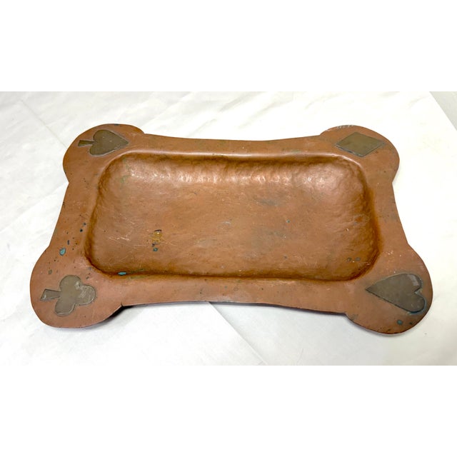 This antique hand hammered thick copper tray features playing card suits done in brass on each corner, making it a unique...