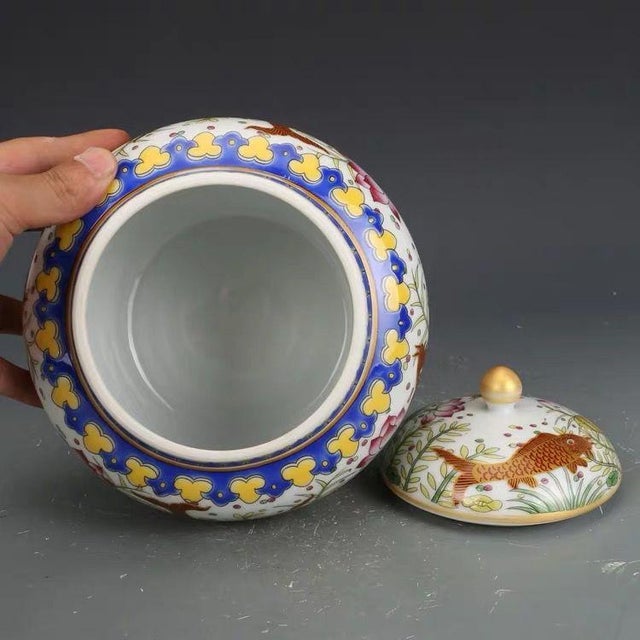 This classic jar features a full, rounded body and is topped with a matching domed lid finished with a striking gold...