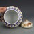 This classic jar features a full, rounded body and is topped with a matching domed lid finished with a striking gold...