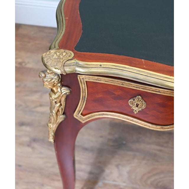 Magnificent French Louis XV style bureau plat dating to circa 1880 The shaped top is inset with black leather and framed...