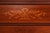 Circa 1900 mahogany five-drawer chest with ribbon inlay, bookmatched flame veneer, fluted legs, and original brass rosette...