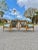 Pair of Rail-Back Lounge Chairs in the Style of Viko Baumritter. Two beautiful lounge chairs with stunning wood grain...