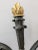 French Empire Bronze Dore Candelabrum featuring a cast gilded flame encircled by five arms ending in gilded sconces below...