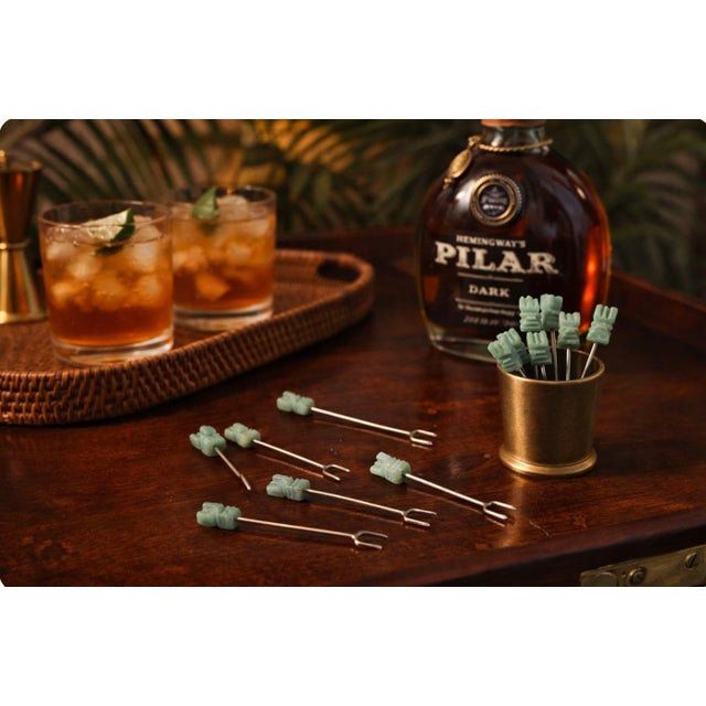 Bring a touch of British Colonial elegance to your bar cart with this set of 12 vintage jade cocktail picks, each...