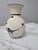 This mid-century style stoneware vase features a warm, speckled sandstone finish. It is intricately decorated by hand with...