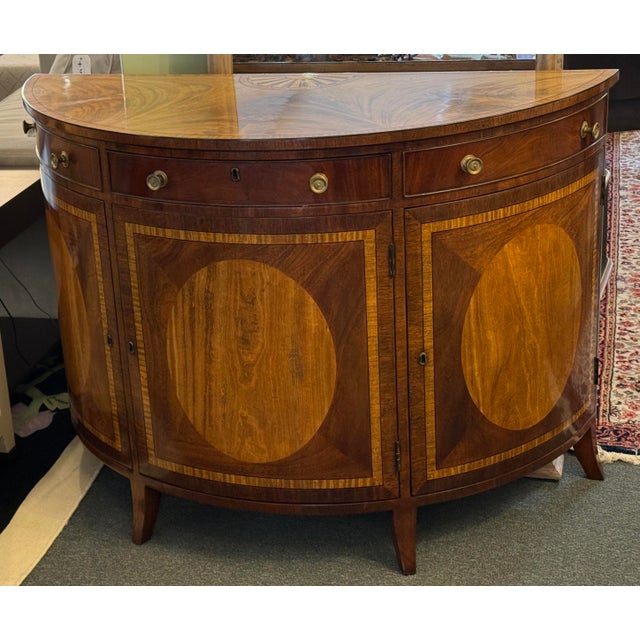 Design Plus Gallery presents a Demi-Lune Commode from Burton Ching. The commode is made with an extensive mid of mahogany,...