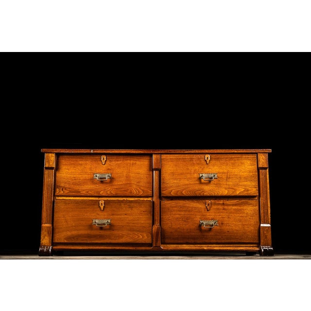 This antique wooden cabinet features beautiful etched feet and intricate geometric patterned drawer pulls. Each of the...