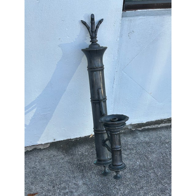 Chic candle power mid-century wall sconces, crafted in bronze in a faux bamboo form with a gunmetal gray patina now...