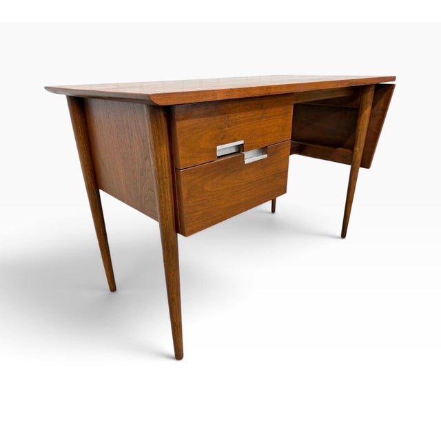 A handsome Mid-Century Modern American of Martinsville “Accord” drop-leaf walnut desk, circa 1960s. Beautifully...